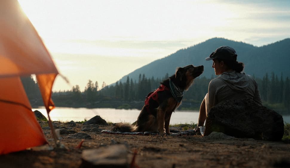 Cristina and Lennon share a moment by their tent in the mountains.