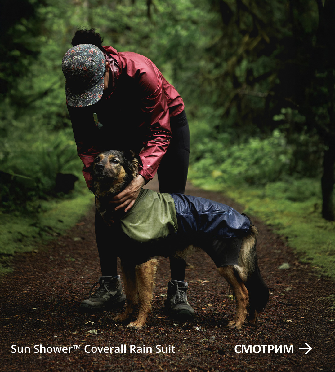 Cristina pets Lennon who's wearing a Sun Shower™ Coverall. Words read SHOP